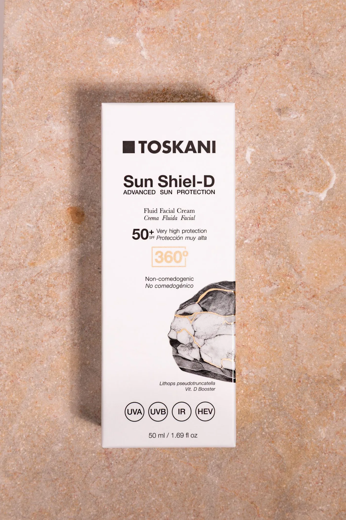 Sun Shiel-D Fluid Facial Cream SPF 50+ auf Travertin